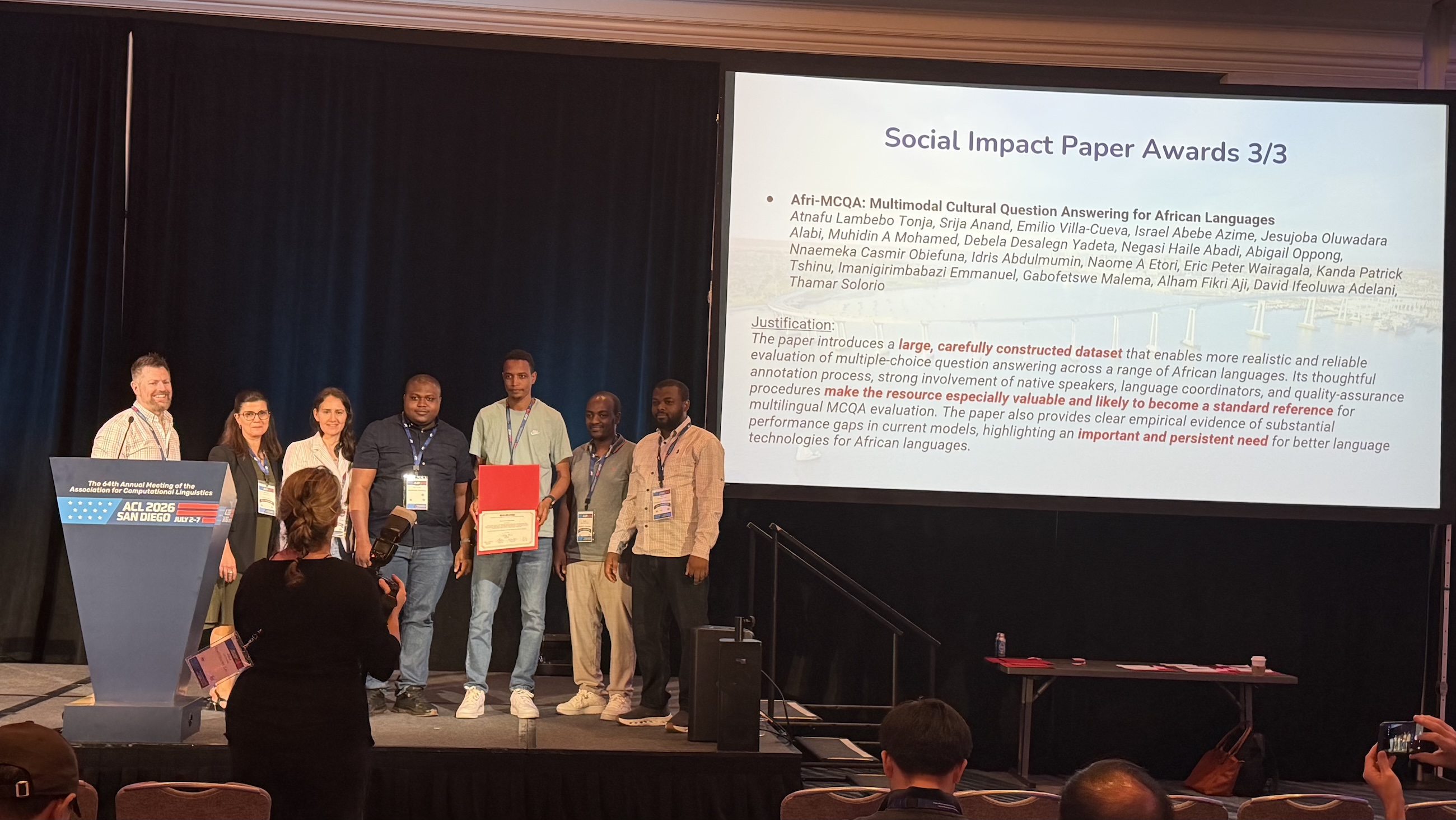 Dr Idris Abdulmumin and Afri-MCQA co-authors on stage receiving the Social Impact Paper Award at ACL 2026