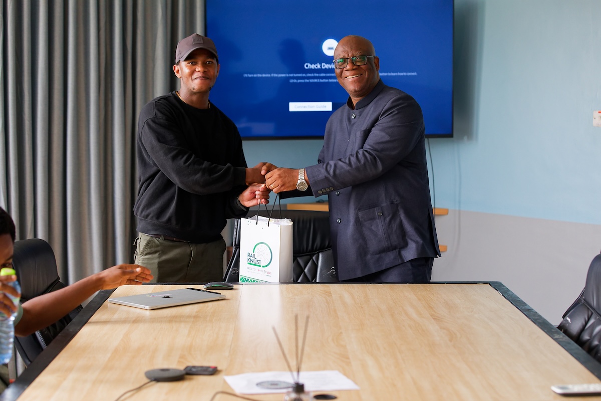 Thapelo Sindane receiving a RAIL KNUST gift bag from his host